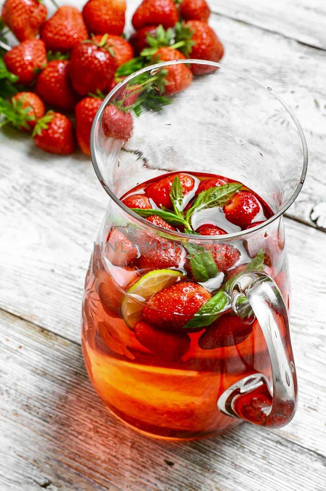 Glass decanter with delicious strawberry compote of fresh berries