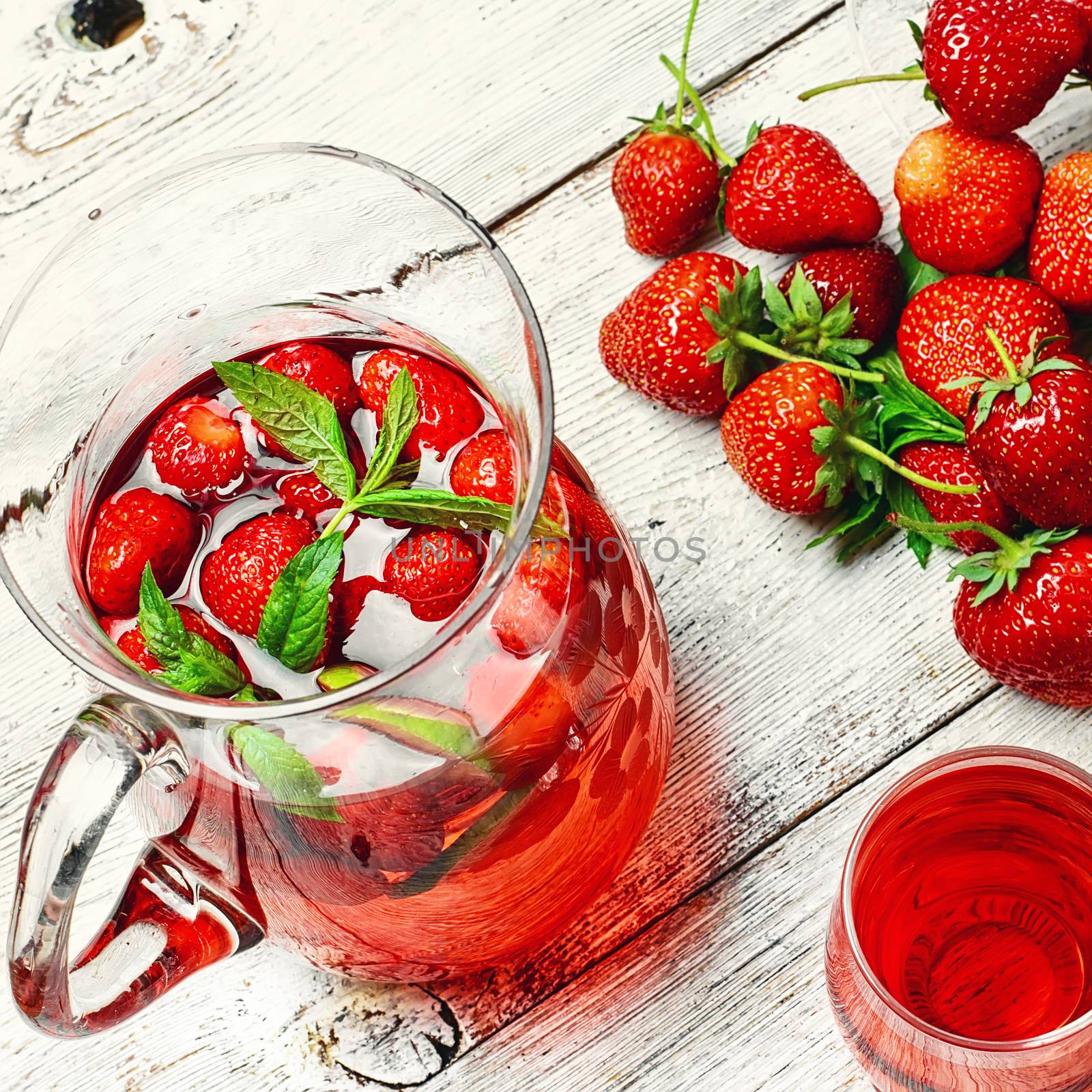 Glass decanter with delicious strawberry compote of fresh berries