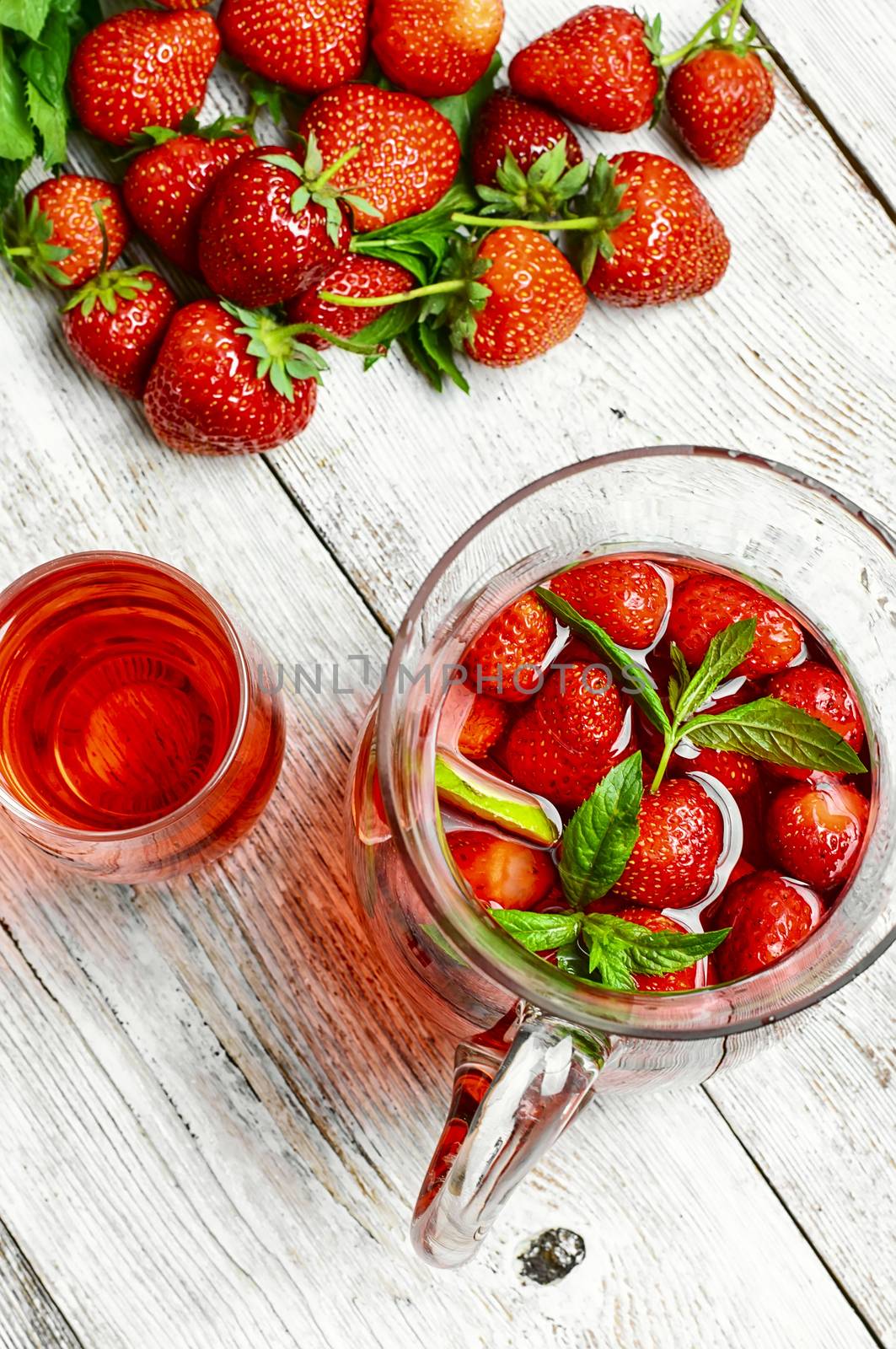 Glass decanter with delicious strawberry compote of fresh berries