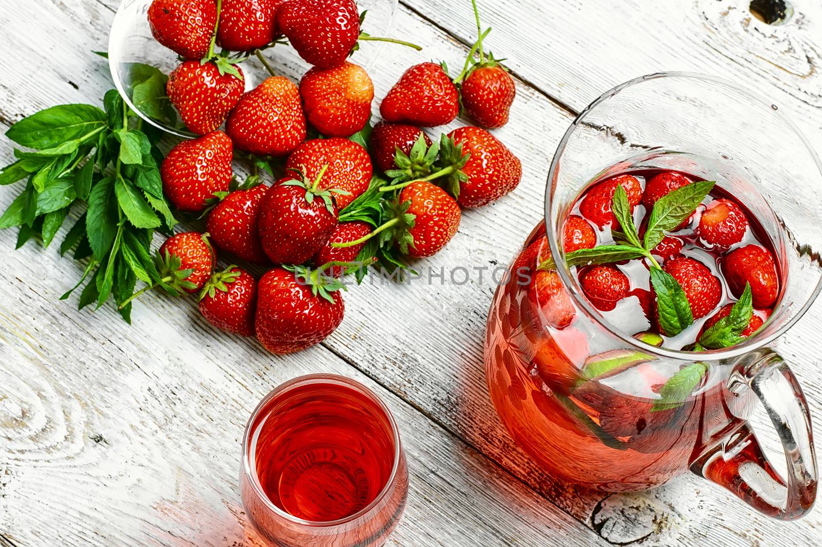 Glass decanter with delicious strawberry compote of fresh berries