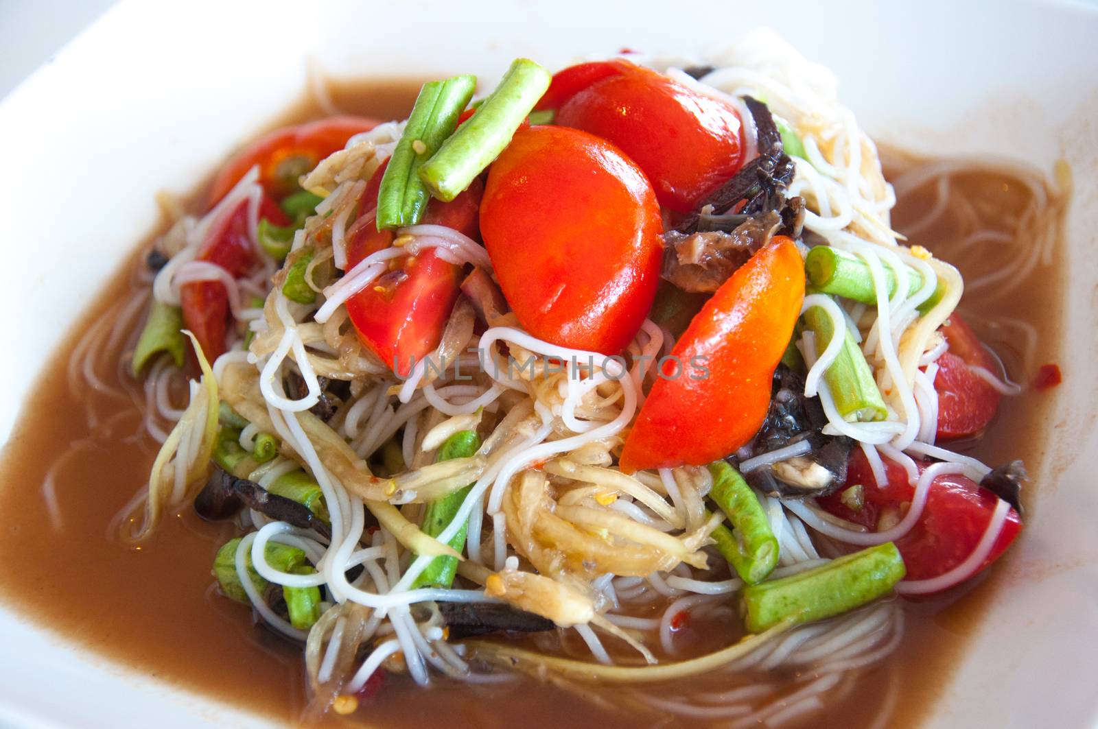 Green papaya salad is a spicy salad made from shredded unripe papaya. It is of Lao origin but it is also eaten throughout Southeast Asia. Locally known in Cambodia as bok l'hong in Laos as tam som or the more specific name tam maak hoong , Lao pronunciation, in Thailand as som tam and in Vietnam as goi du du. Som tam, the Thai variation, was listed at number 46 on World's 50 most delicious foods compiled by CNN Go in 2011