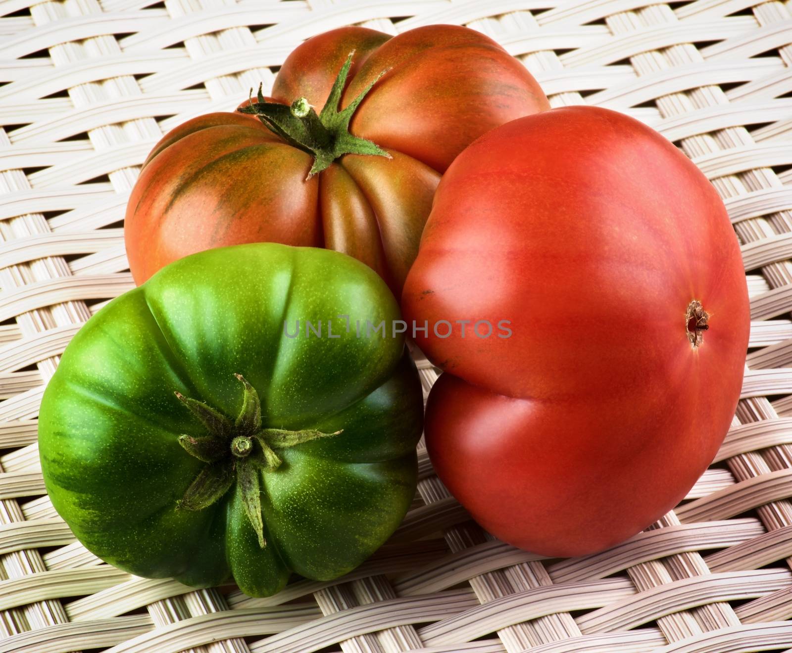 Arrangement of Red, Green and Orange Raw Ripe Tomatoes with Stems closeup on Wicker background. Sort Fields Raf 