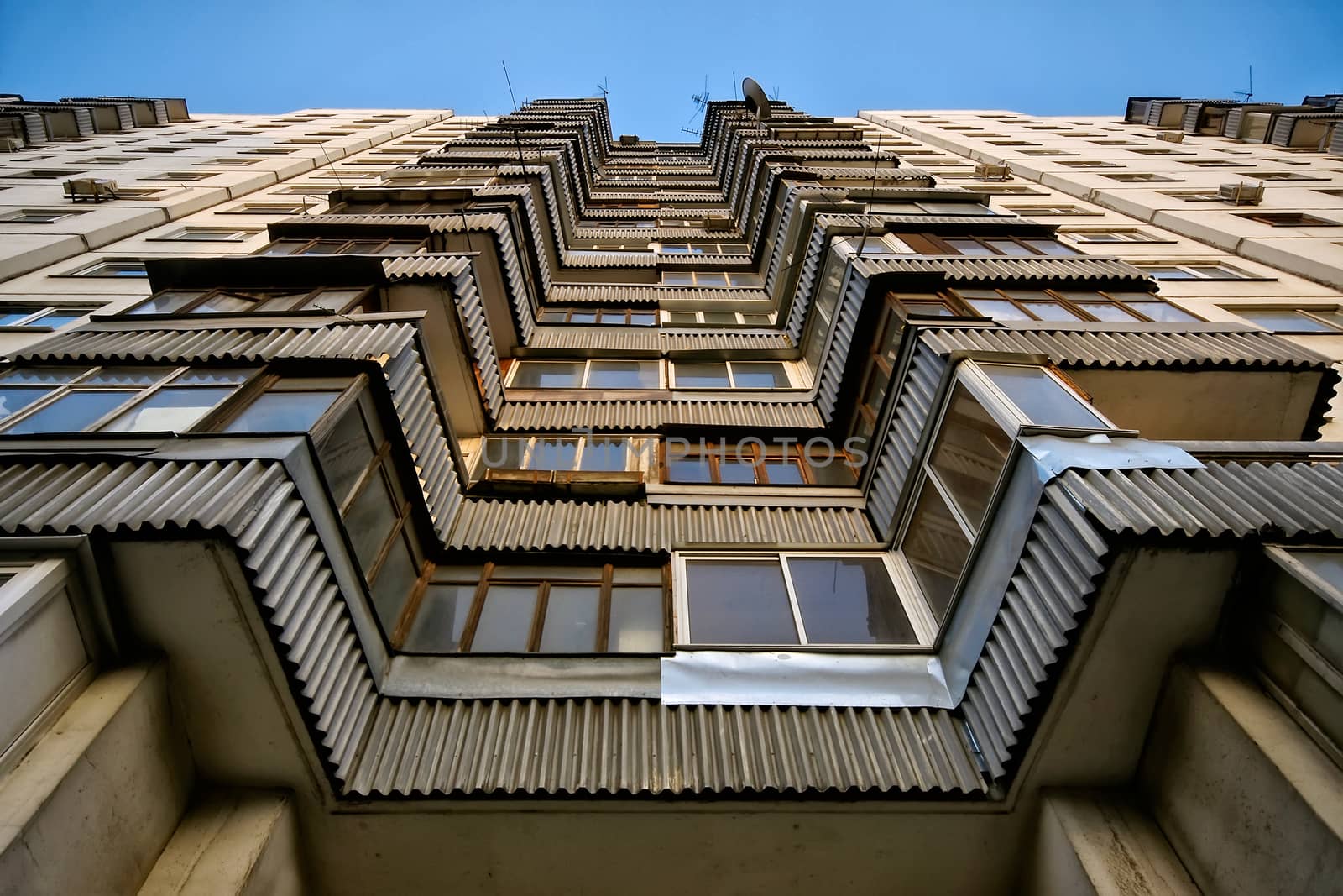 Modern apartment building. Front view. Divercity of windows.