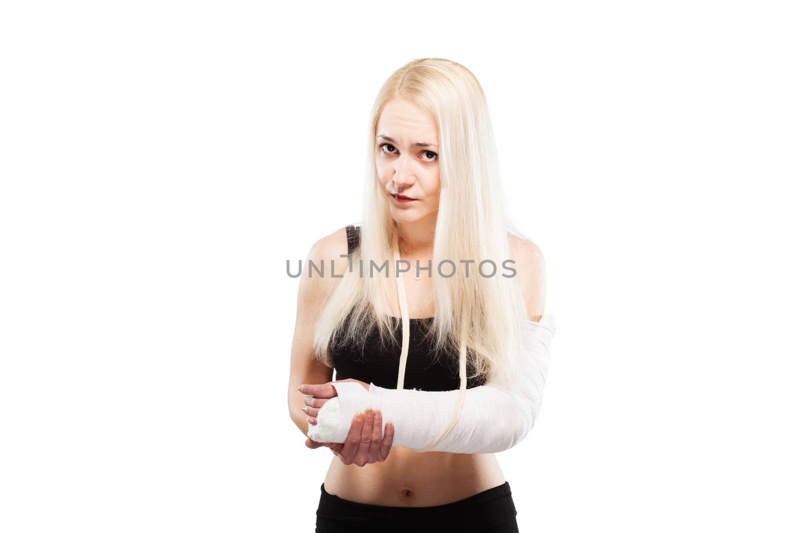 Blond girl with a broken arm in plaster looking sad
