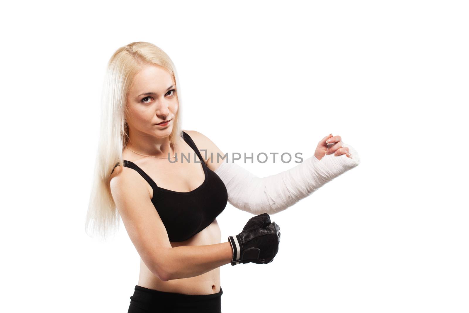 Fitness blond girl with a broken arm in plaster, boxing pose