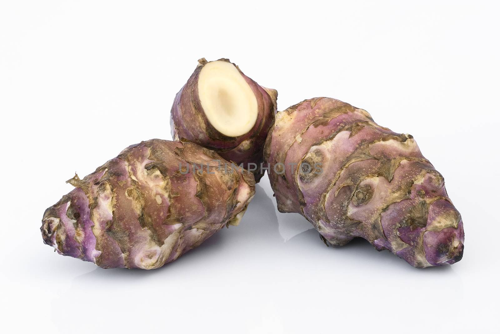 Topinambur root  isolated on white background. Also known as Jerusalem artichoke (Helianthus tuberosus). Edible rhizome native to North America with a taste similar to the artichoke.