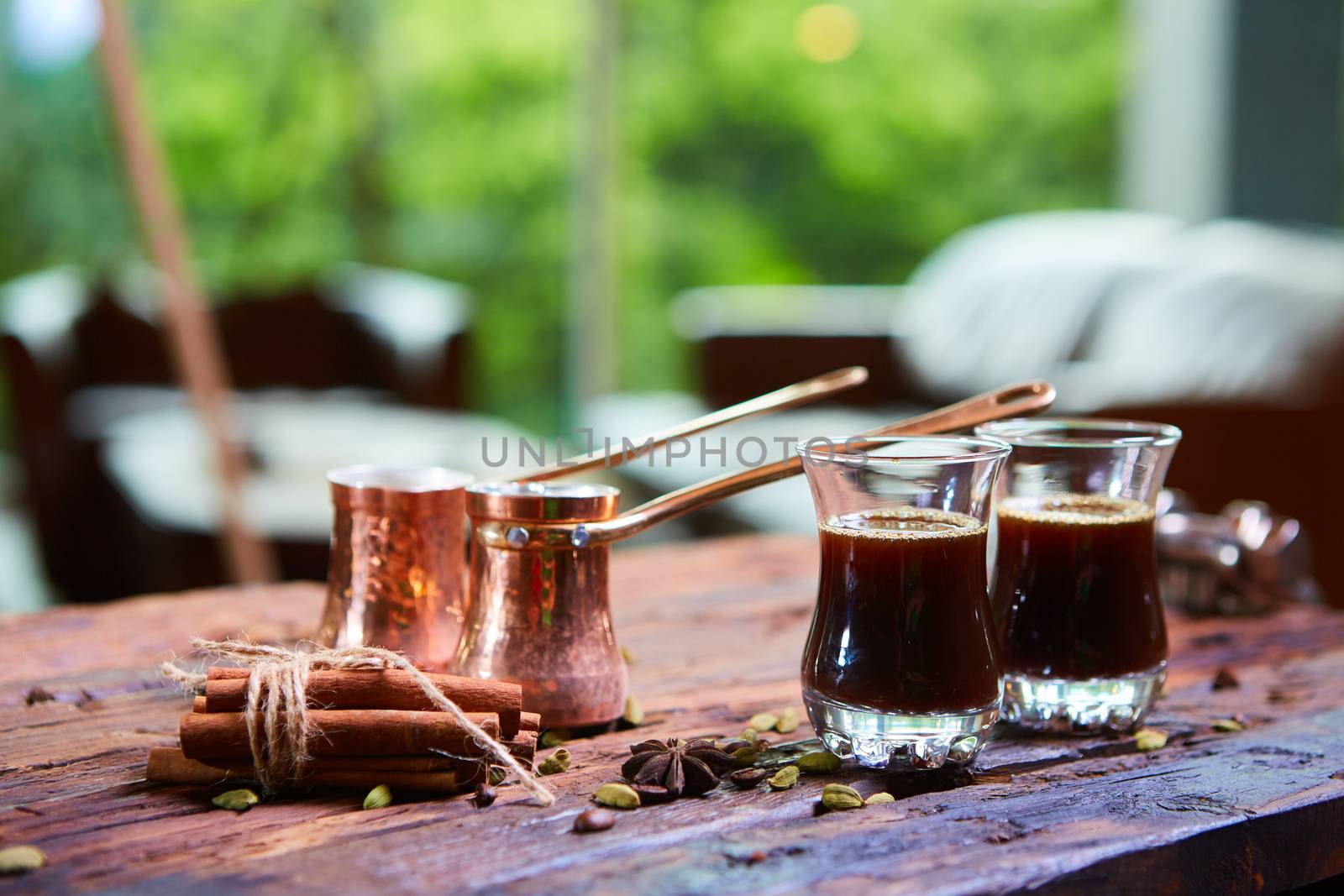 To pour arabic coffee in cups on wooden background. Glass cups