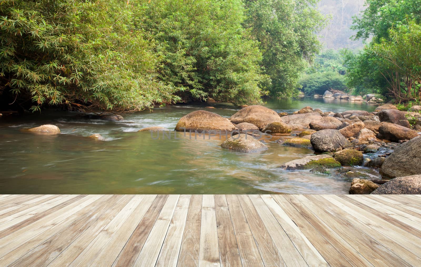 Wood table and river and stone with tree in forest beautiful nature of Asian.