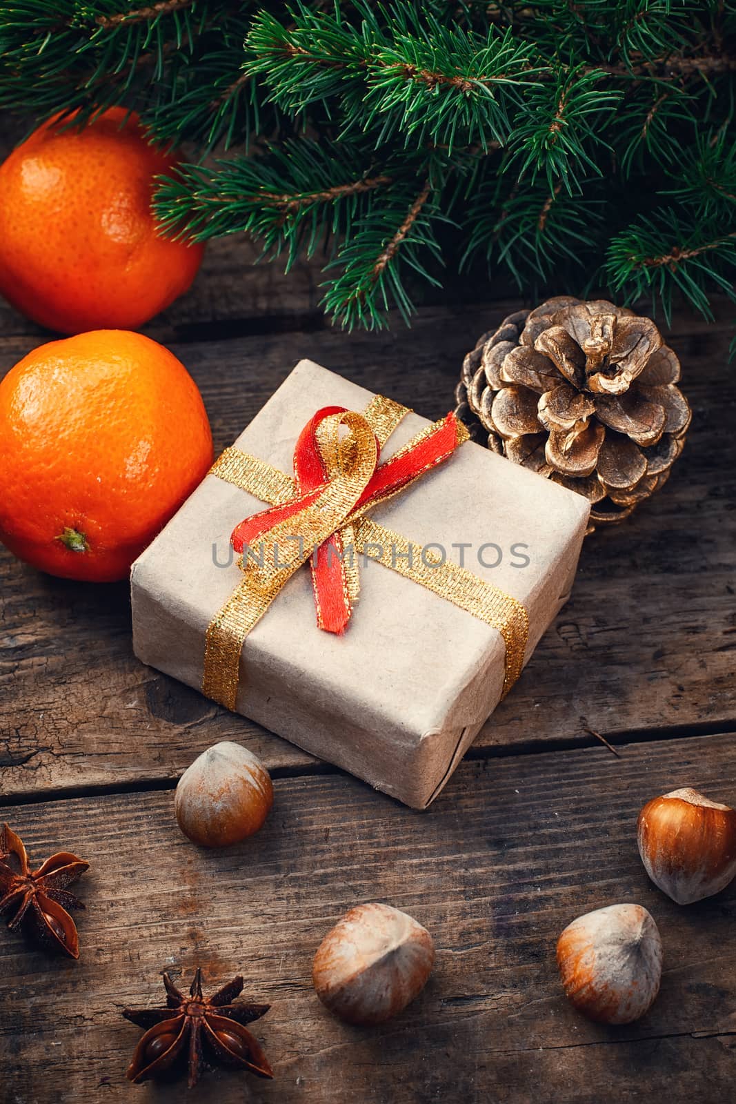Cardboard box with gift for Christmas,pinecone,tangerines and fir