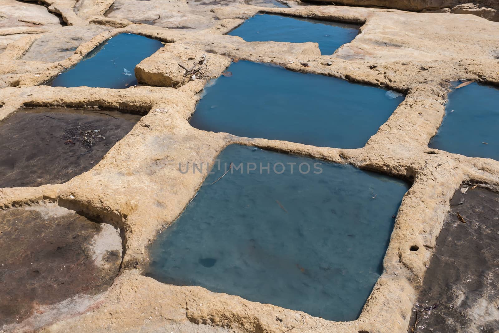 Holes in rocks at the seaside of the Mediterranean sea, for evaporation the water and getting sea salt. City Marsaskala, island Malta.