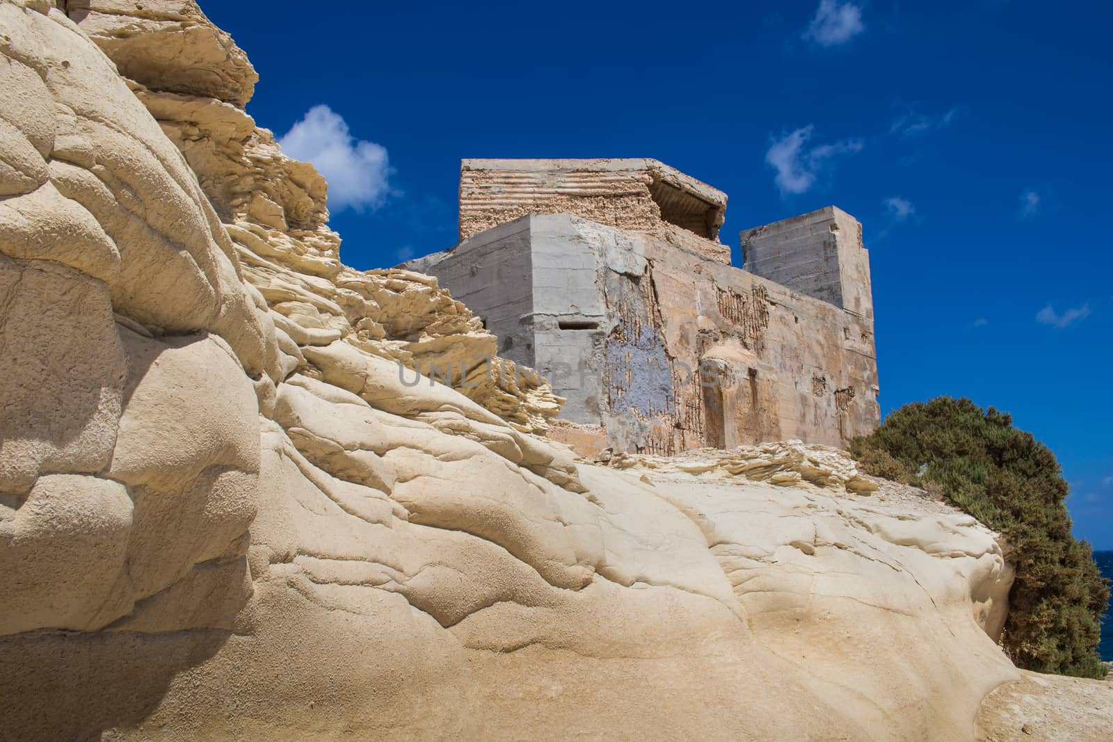 Coastal rocks and a building, island Malta by YassminPhoto