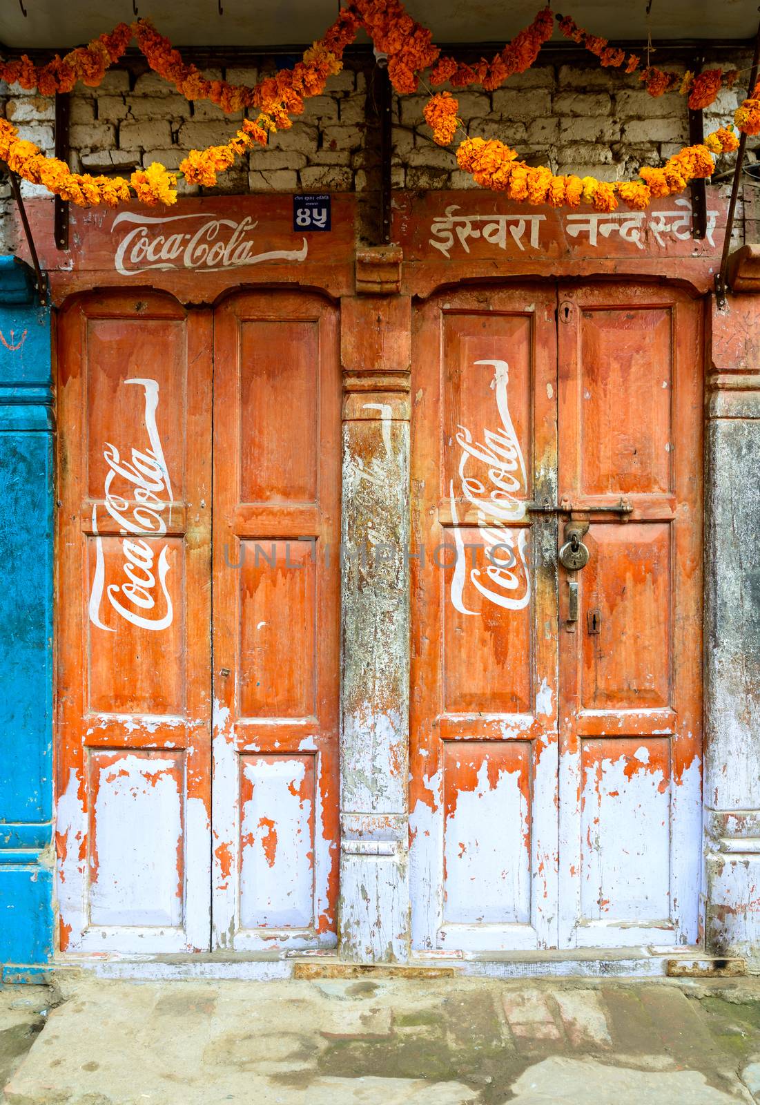 Vintage Coca-Cola sign on doors by dutourdumonde