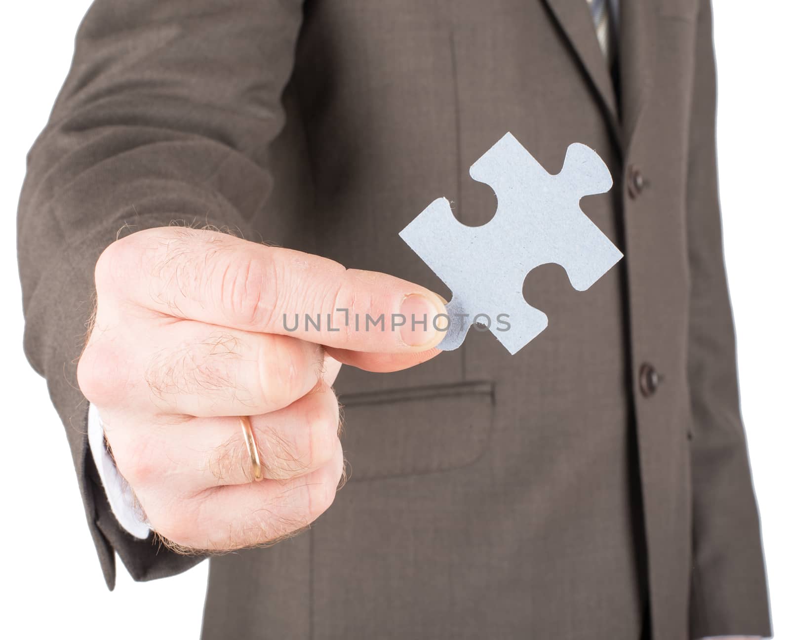 Businessman holding piece of grey puzzle isolated on white background