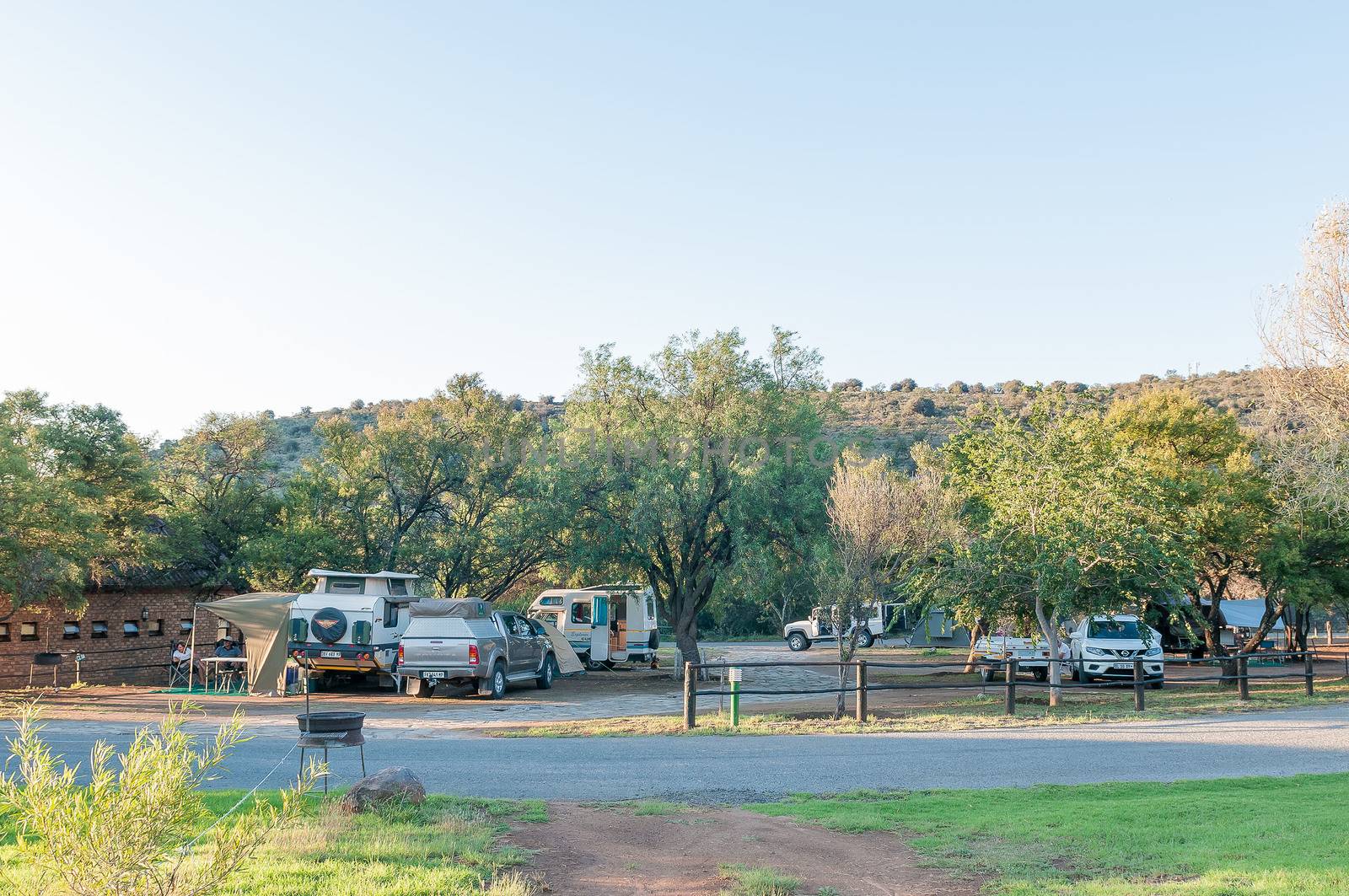 MOUNTAIN ZEBRA NATIONAL PARK, SOUTH AFRICA - FEBRUARY 18, 2016: Tents, a caravan, motorhome and vehicles at the camping grounds in the Mountain Zebra National Park near Cradock at sunset