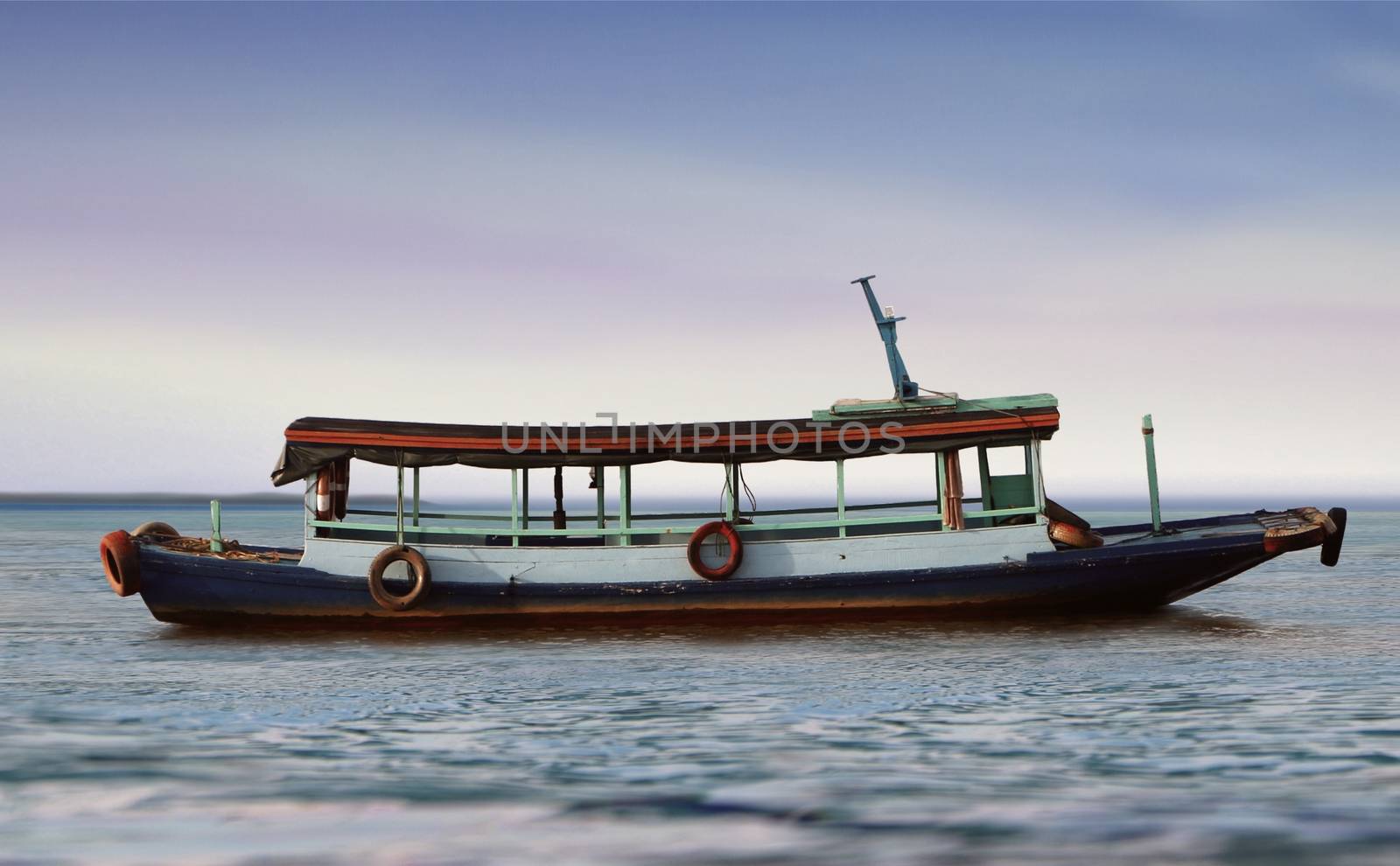 Small empty passenger boat at sea by razihusin