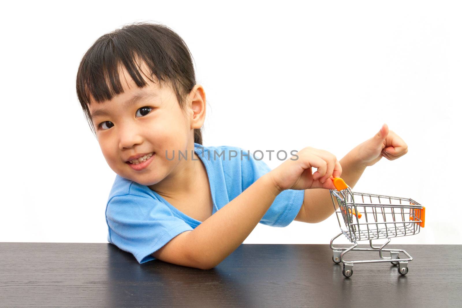Chinese little girl pushing a toy shopping cart by kiankhoon