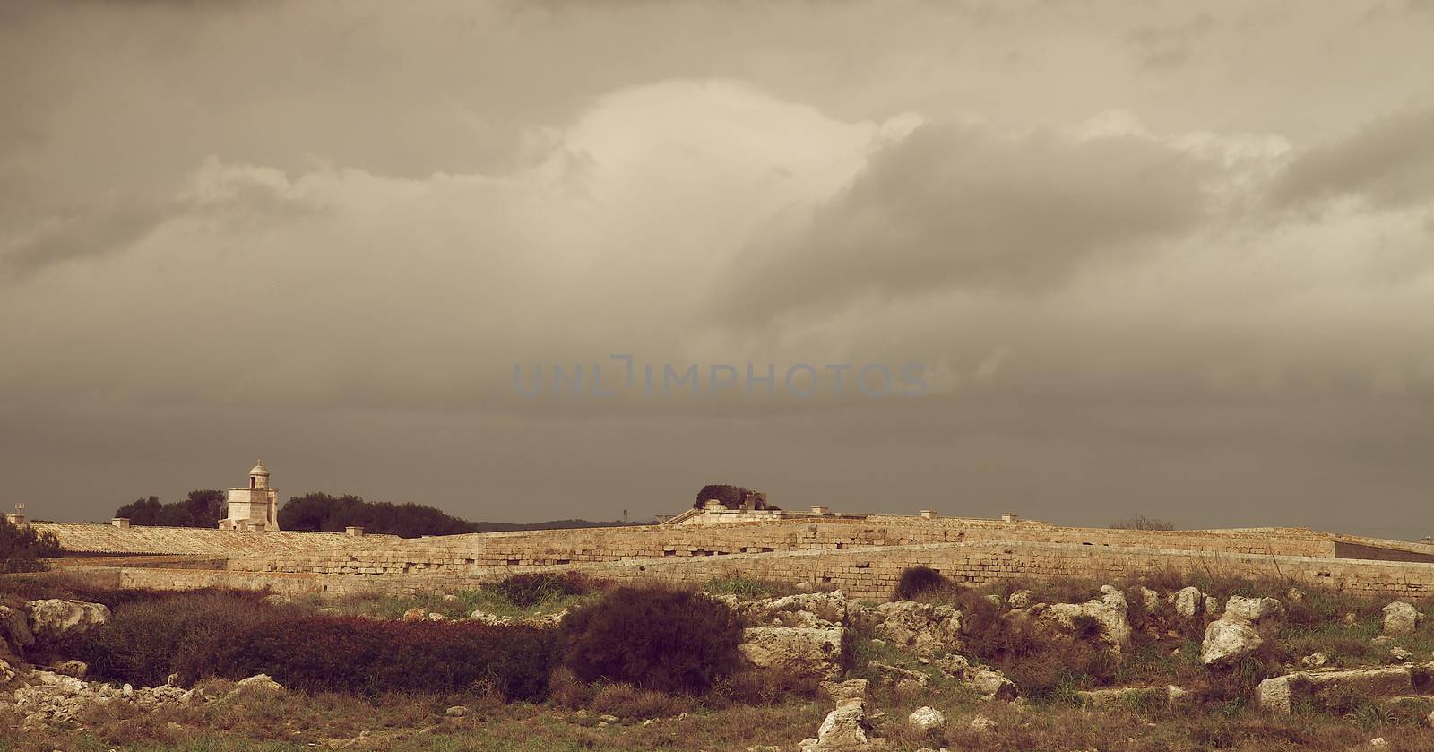 Castle Walls and Watchtower of La Mola Fortaleza Isabel II in Cloudy Day Outdoors, Menorca, Balearic Islands. Retro Styled 
