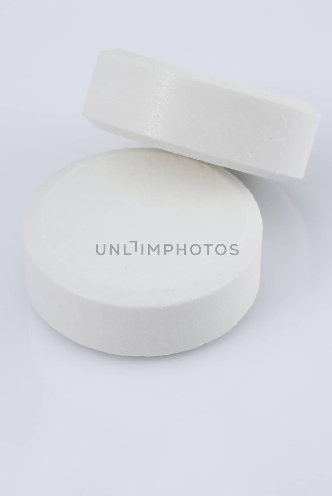 white pills on a white background 