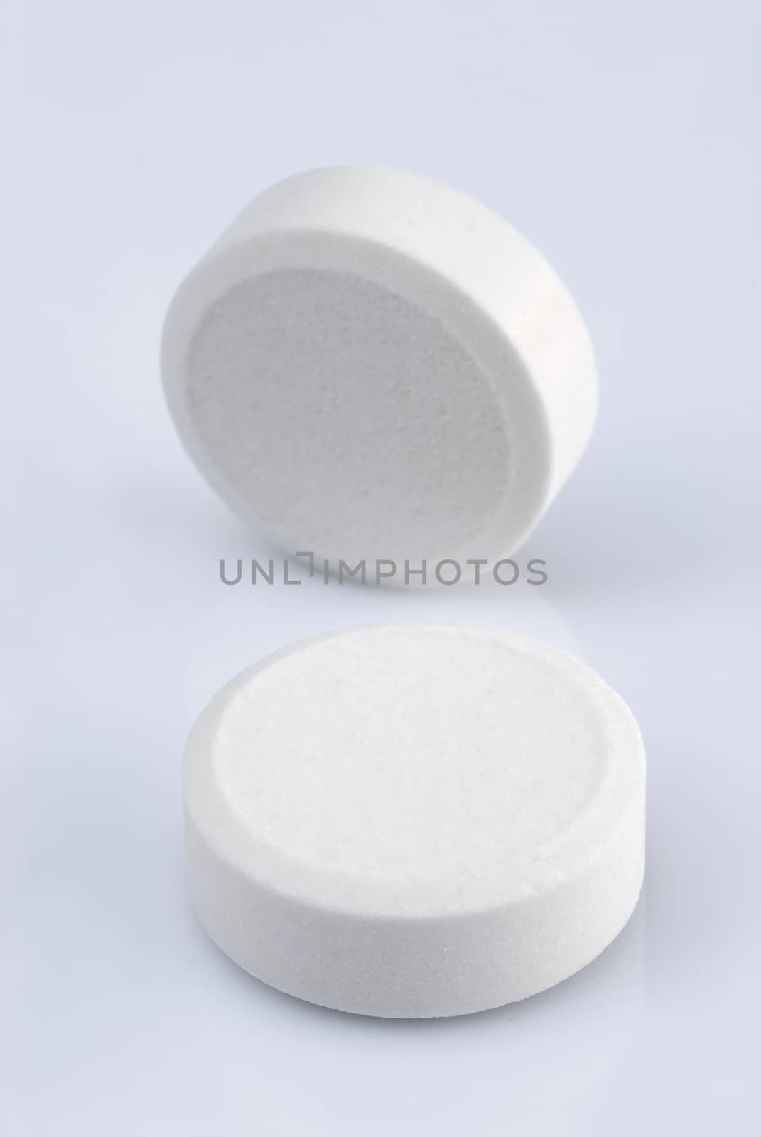 white pills on a white background 