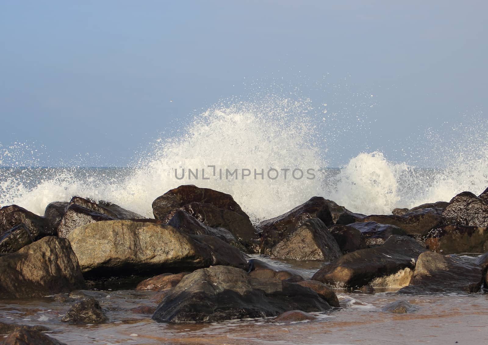 Waves breaking against large stones at Northern Sea