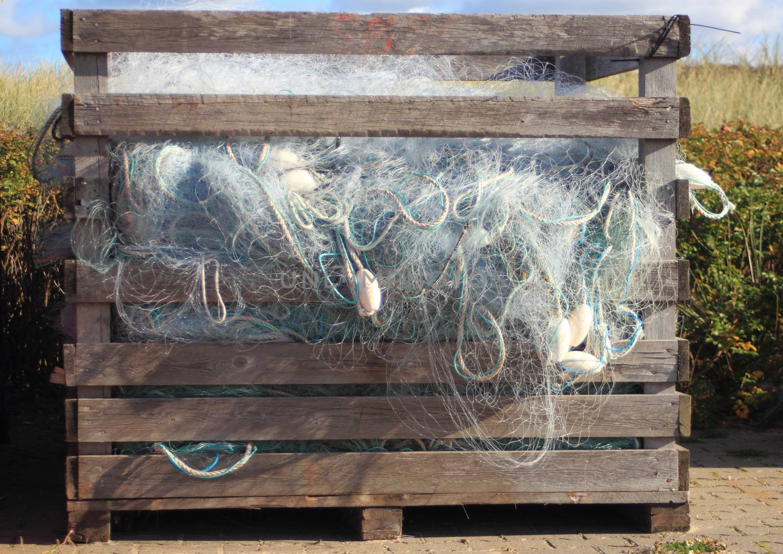 Blue industry fishing nets in old wooden storage box