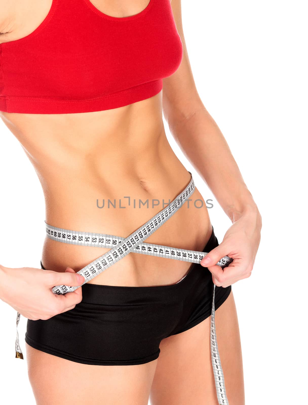 Slim woman measures her waistline, isolated on a white background