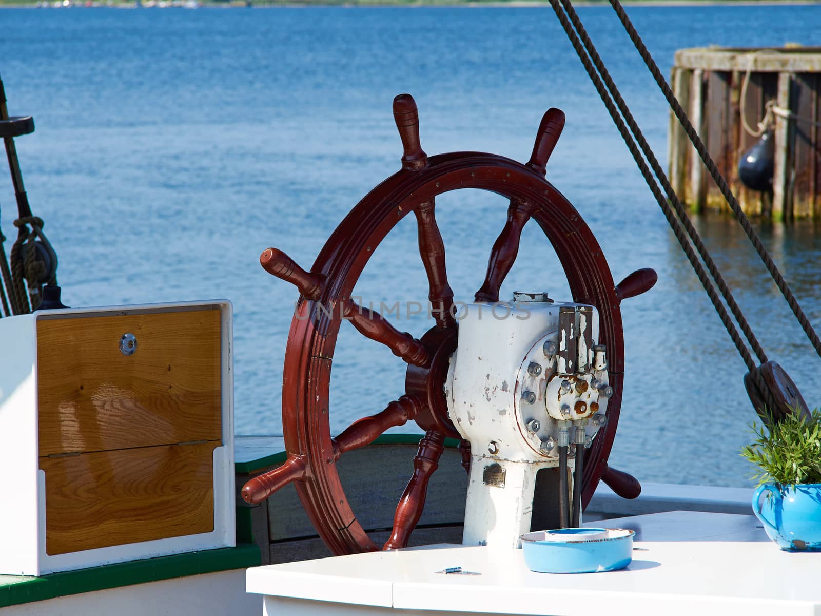 Beautiful traditional wooden ship steering wheel on a  sailing boat