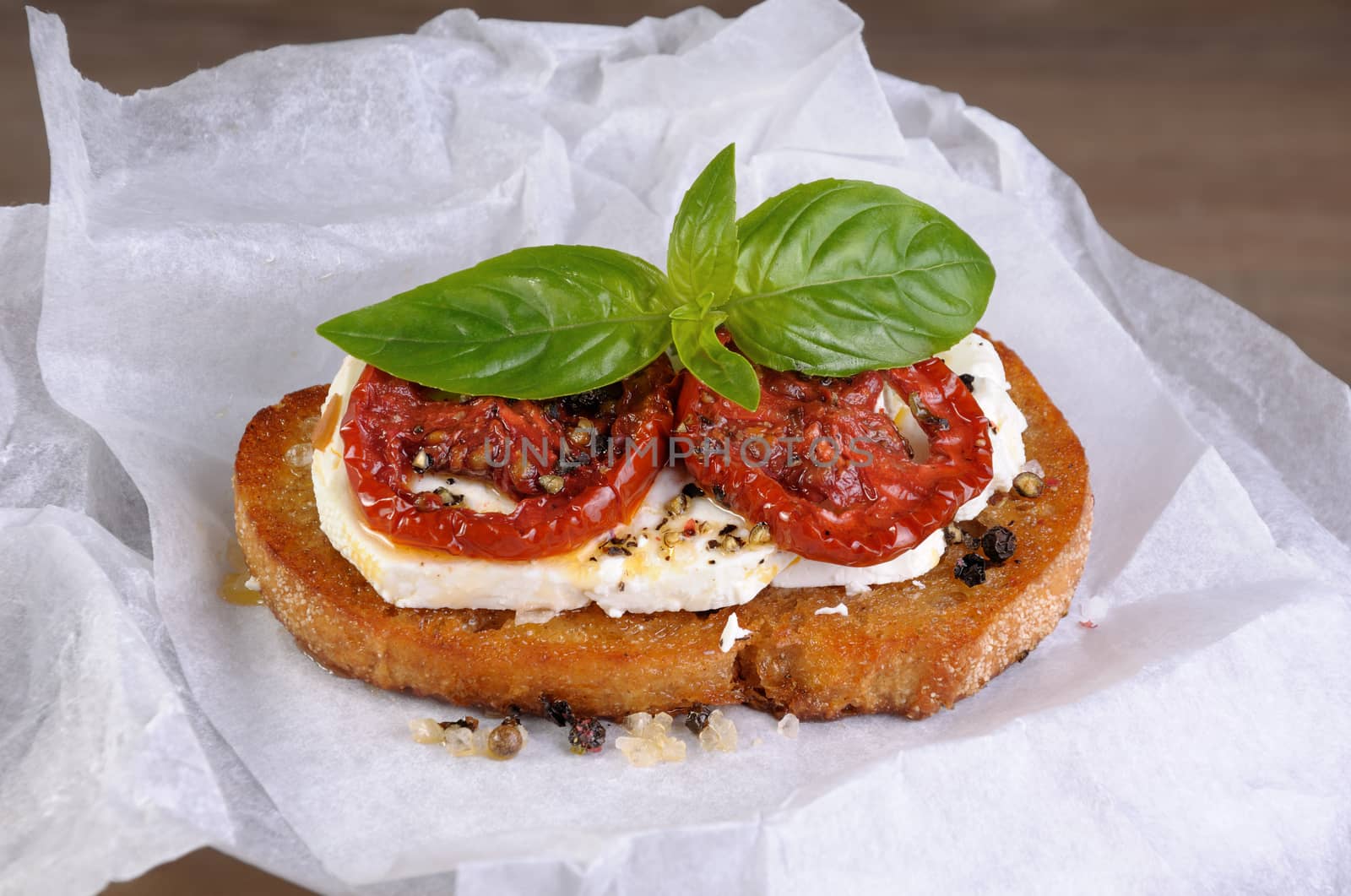 Bruschetta with feta and sun-dried tomatoes slices spiced