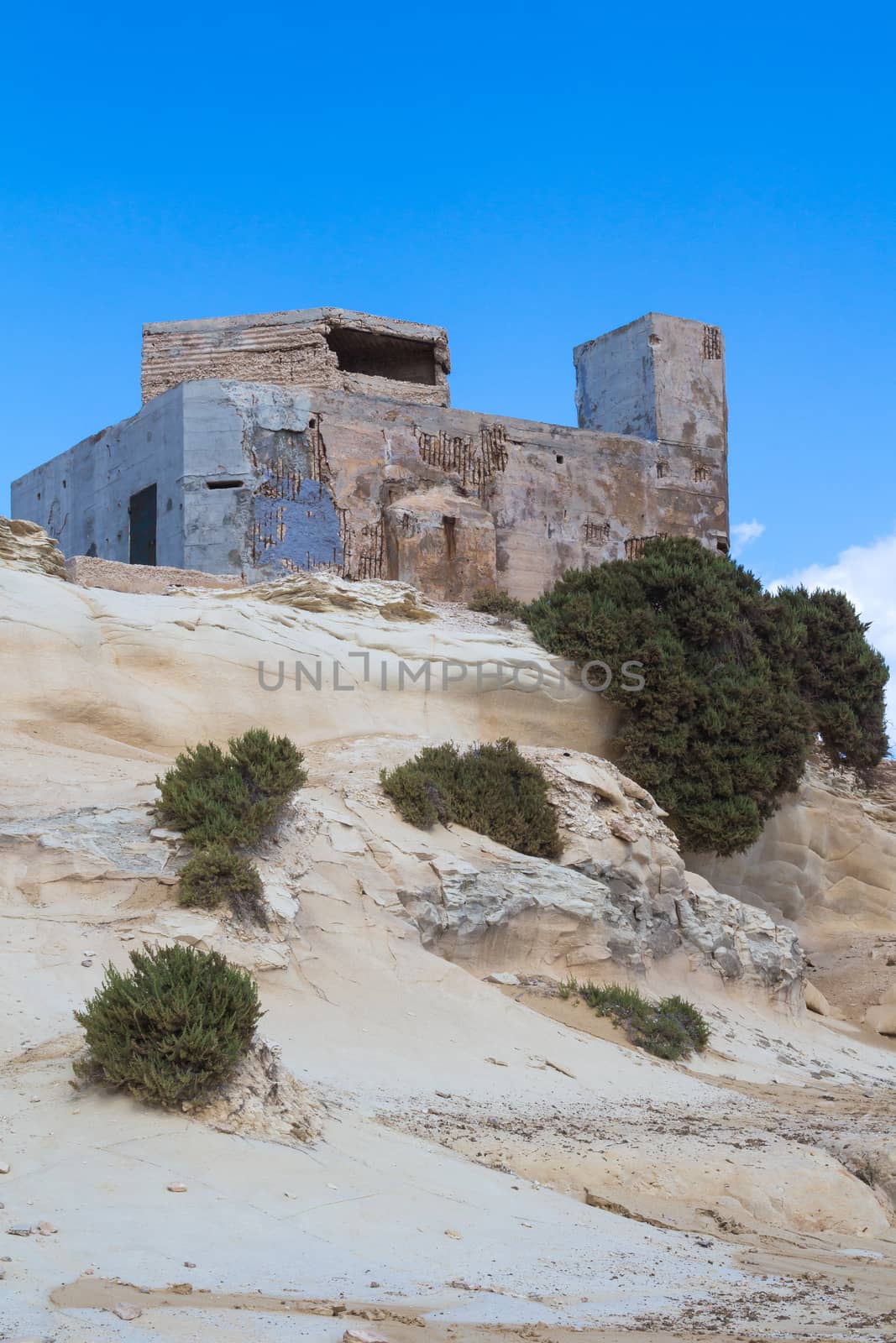 Coastal rocks and a building, island Malta by YassminPhoto