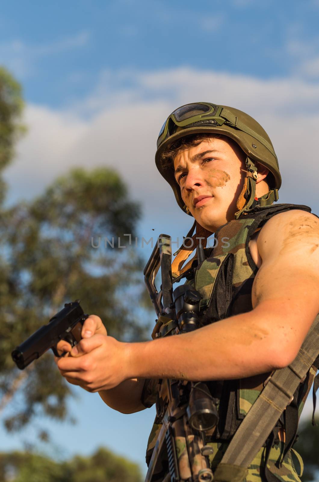 young a soldier in the uniform with weapon