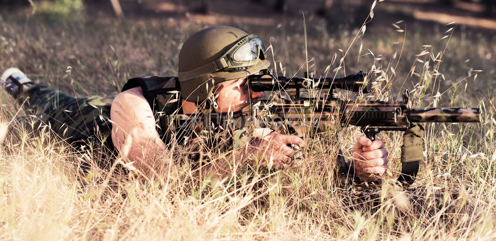 young a soldier in the uniform with weapon