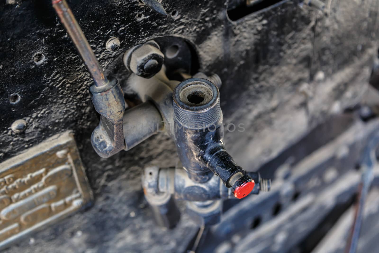 Close up detailed view of industrial iron valves and cables used in mechines.