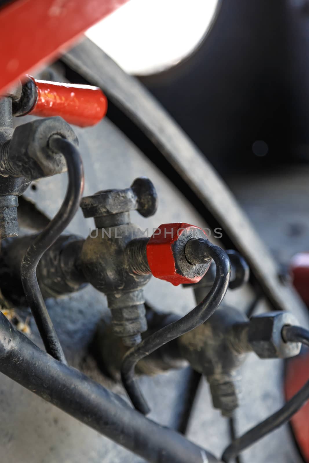 Close up detailed view of industrial iron valves and cables used in mechines.