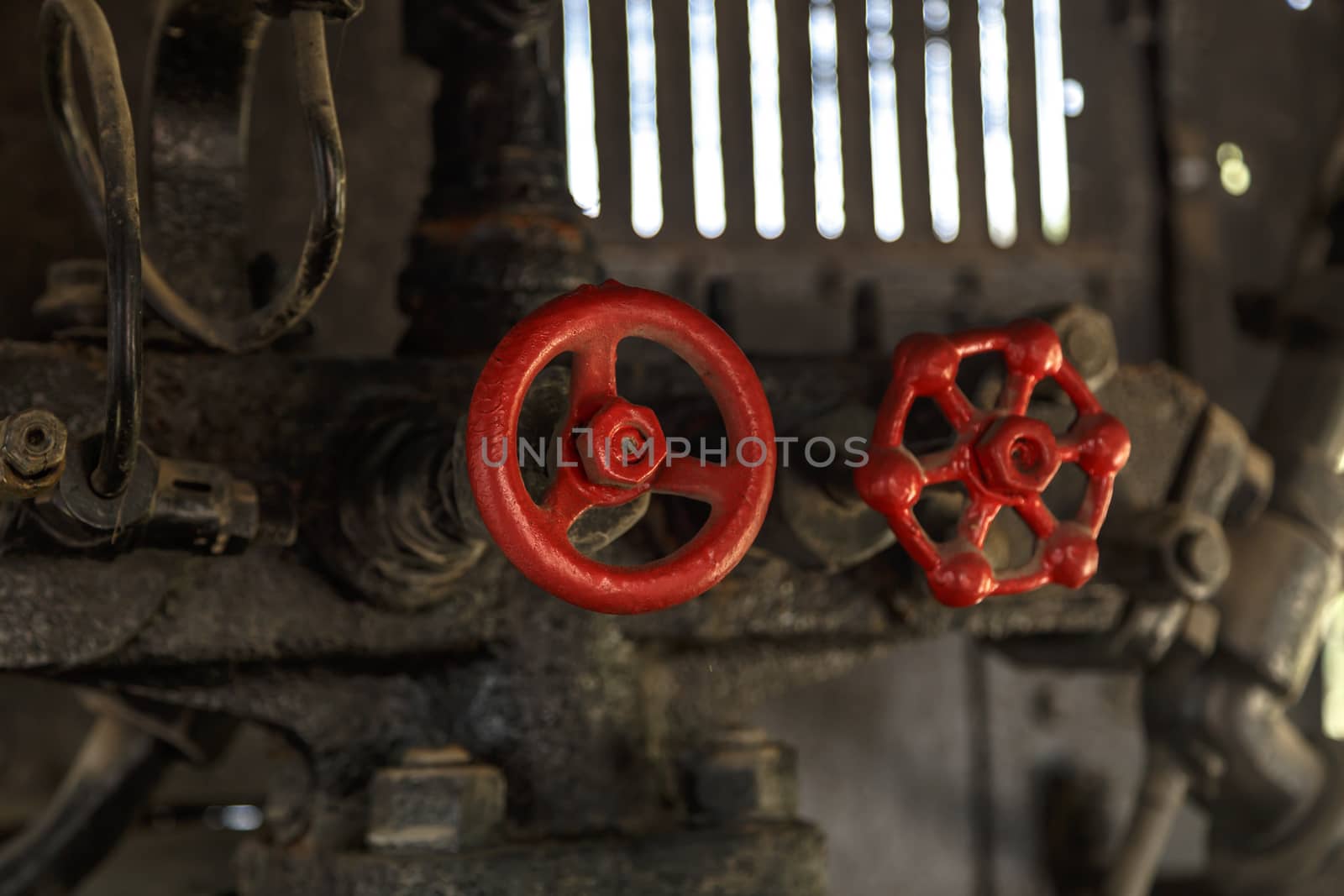 Close up detailed view of industrial iron valves and cables used in mechines.