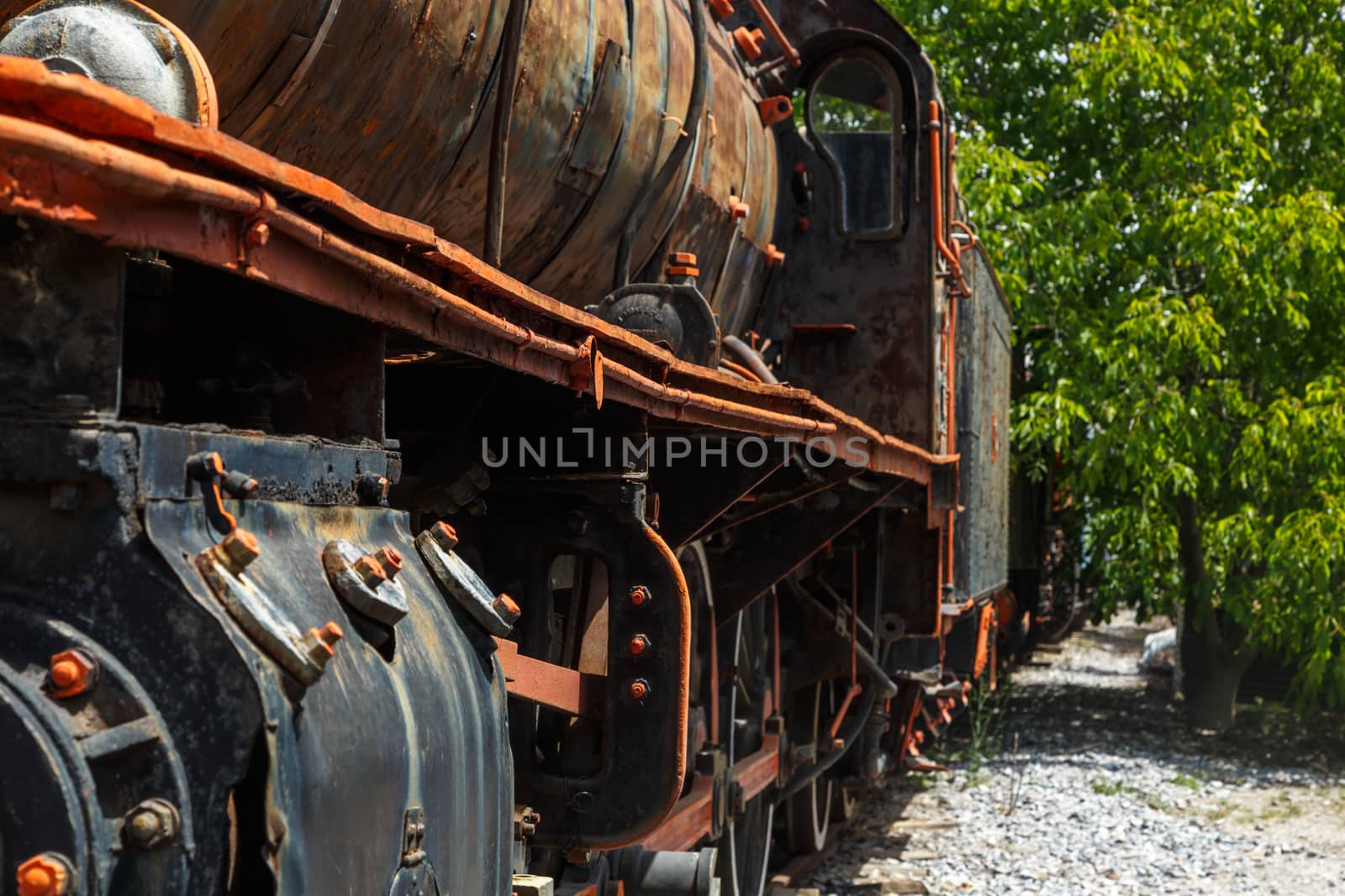 Close up detailed view of historical old rusty iron train locomotives.