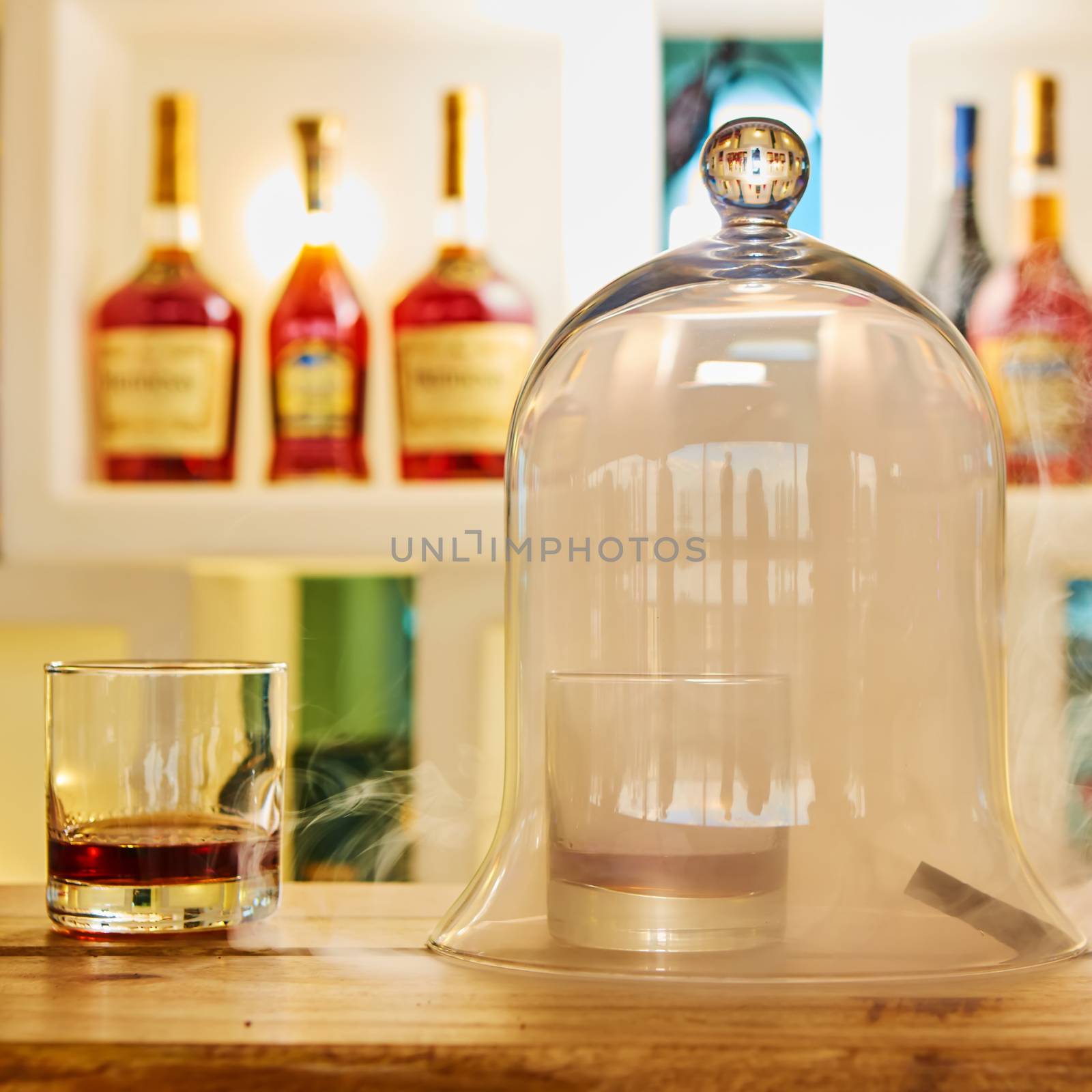 Guatemalan rum under a glass dome with smoke.