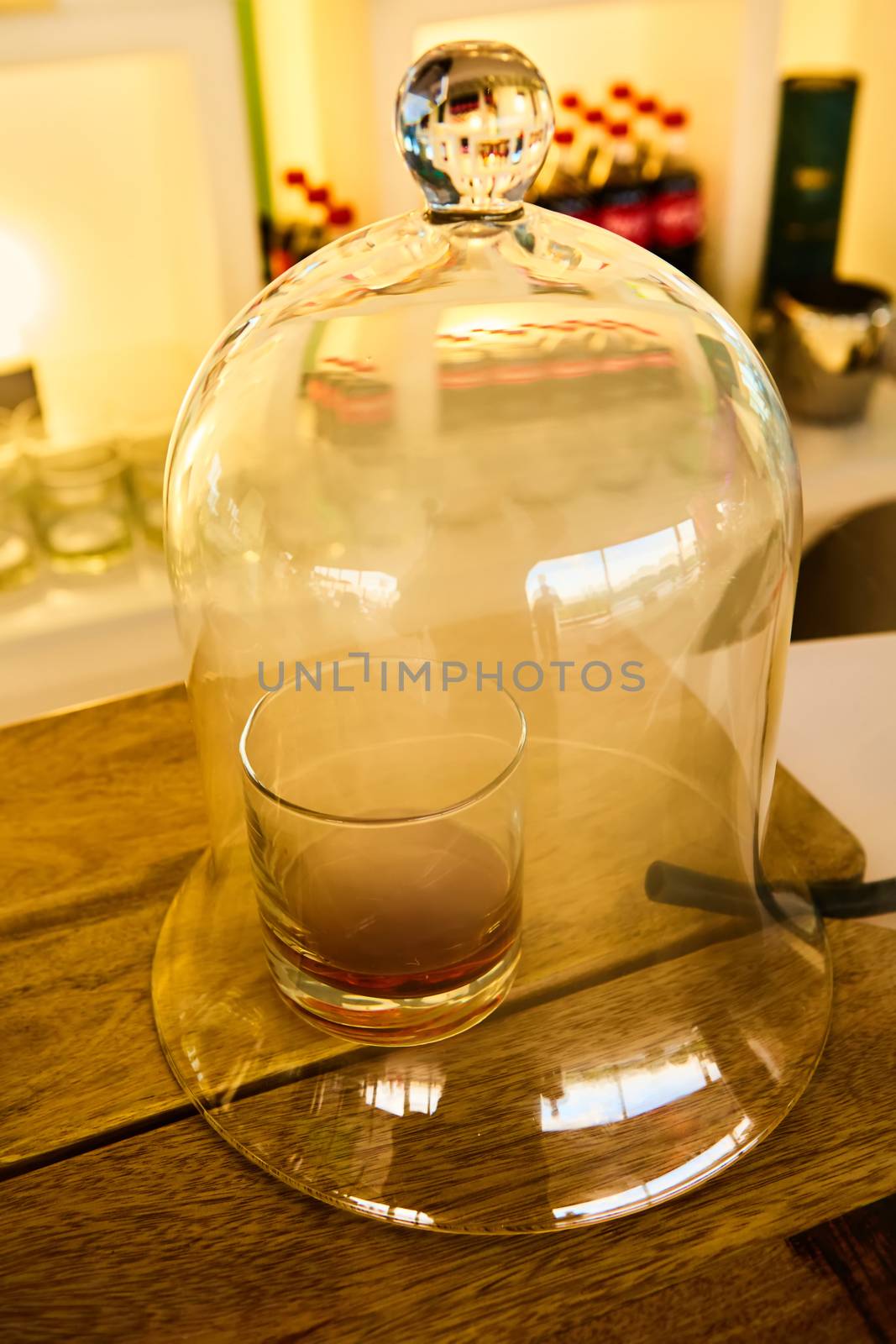 Guatemalan rum under a glass dome with smoke.