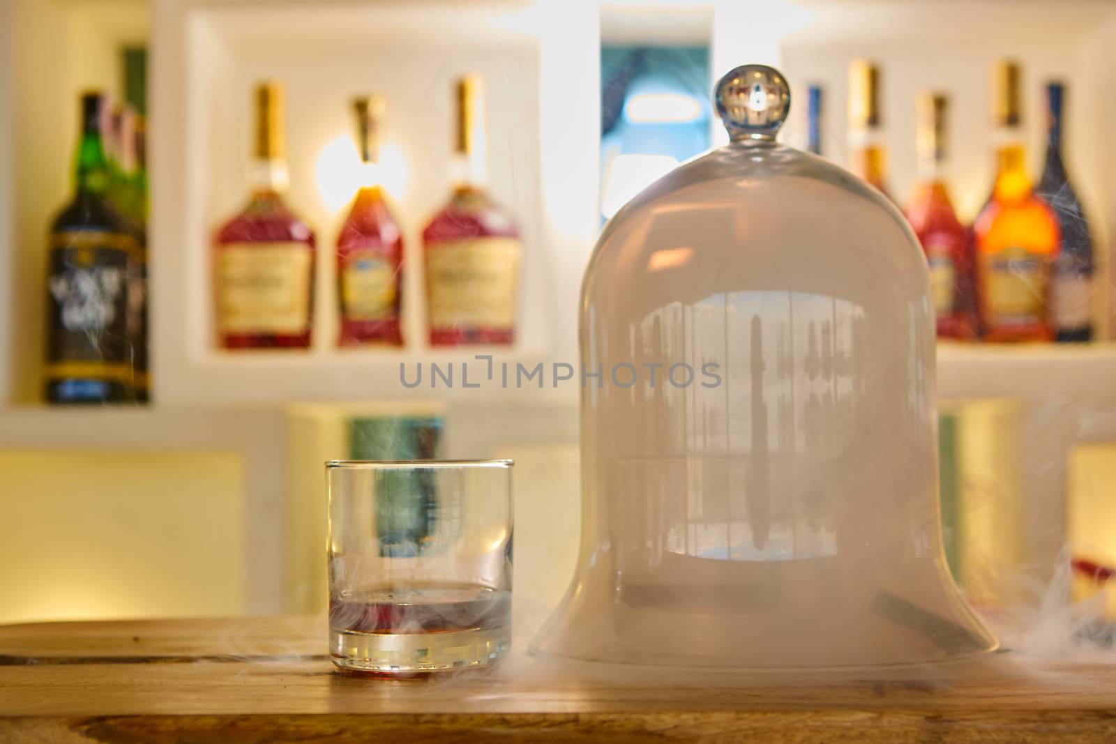 Guatemalan rum under a glass dome with smoke.
