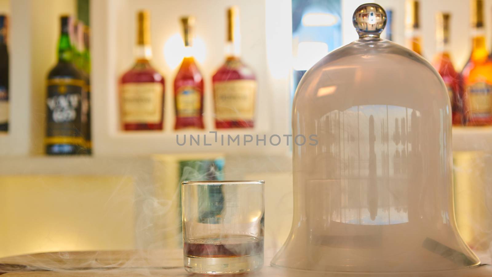 Guatemalan rum under a glass dome with smoke.
