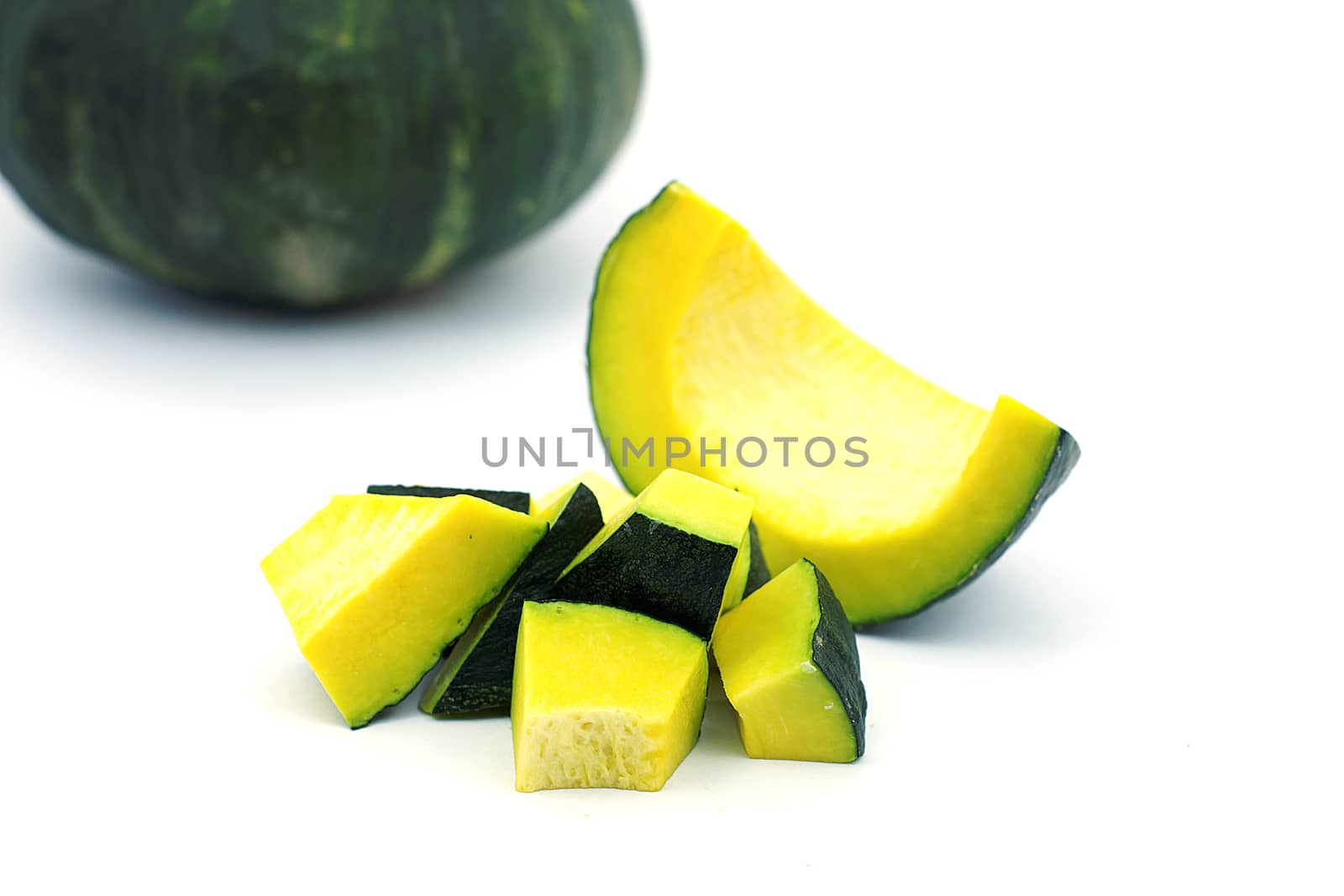 Sliced raw yellow pumpkin on white background. Sliced yellow pumpkin and green pumpkin for use as cooking ingredients