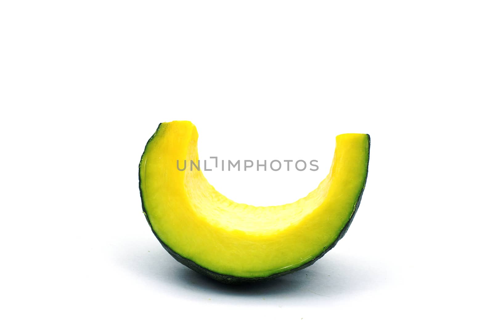 A piece of pumpkin on white background. A sliced seedless pumpkin on white background.