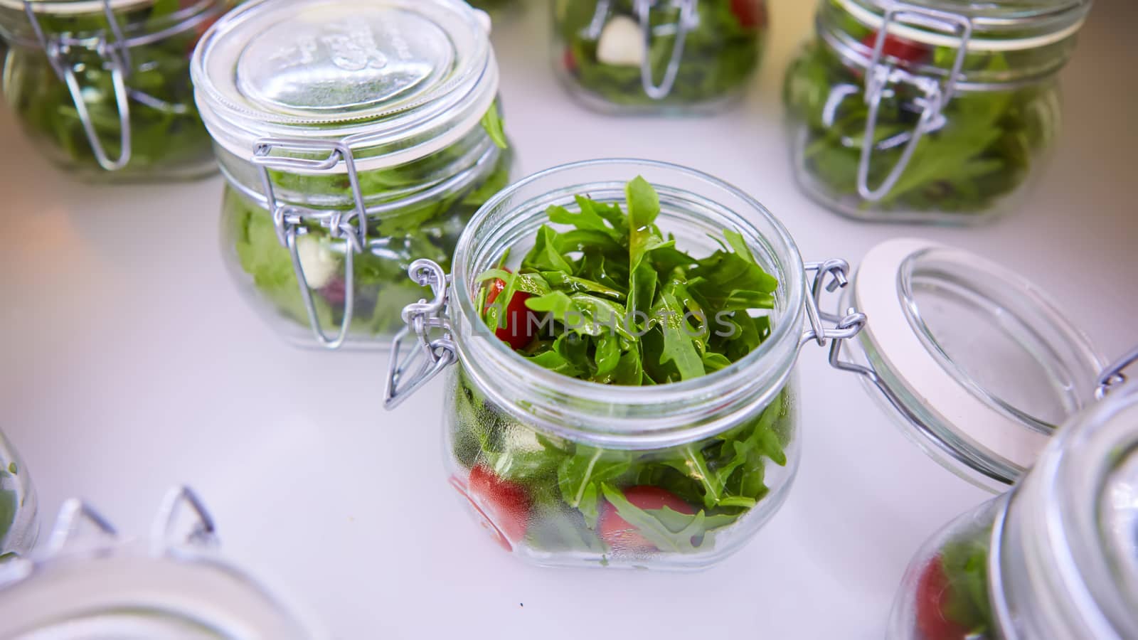 vegetable salad in glass jar on white background. Shallow dof