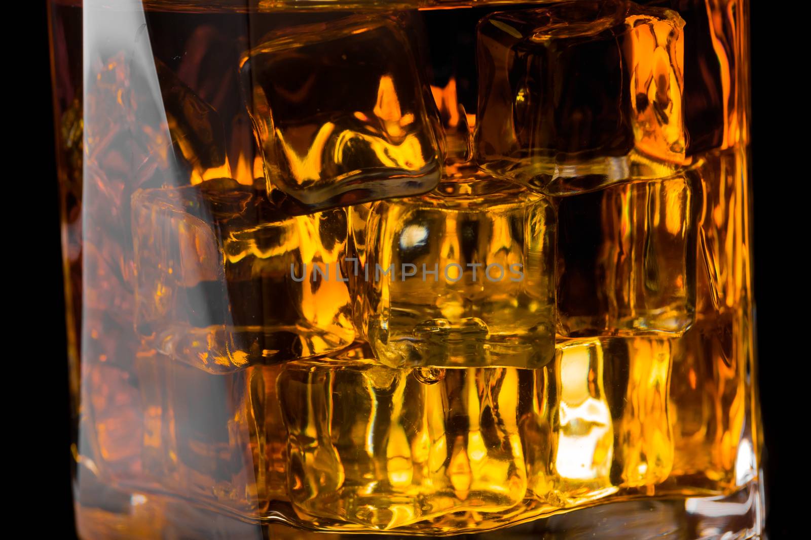 Whisky and Ice on a black glass table