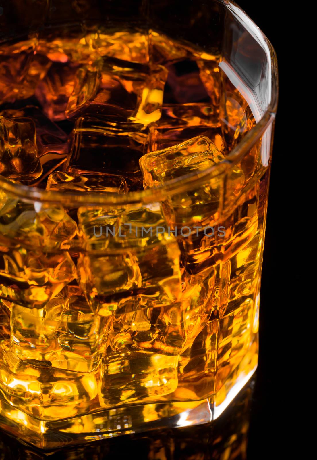 Whisky and Ice on a black glass table