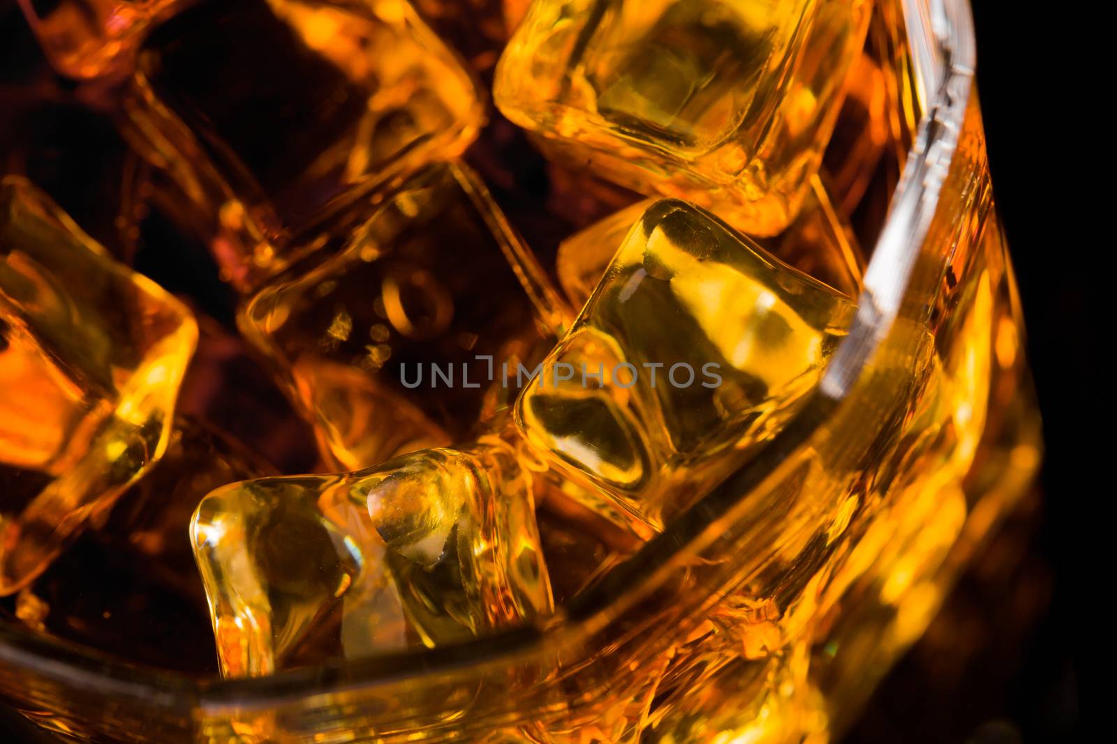 Whisky and Ice on a black glass table