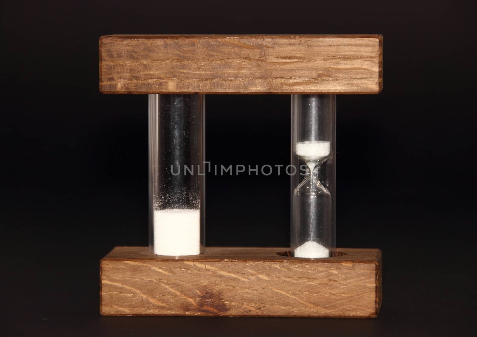 Isolated hourglass with analog and digital speed on black background