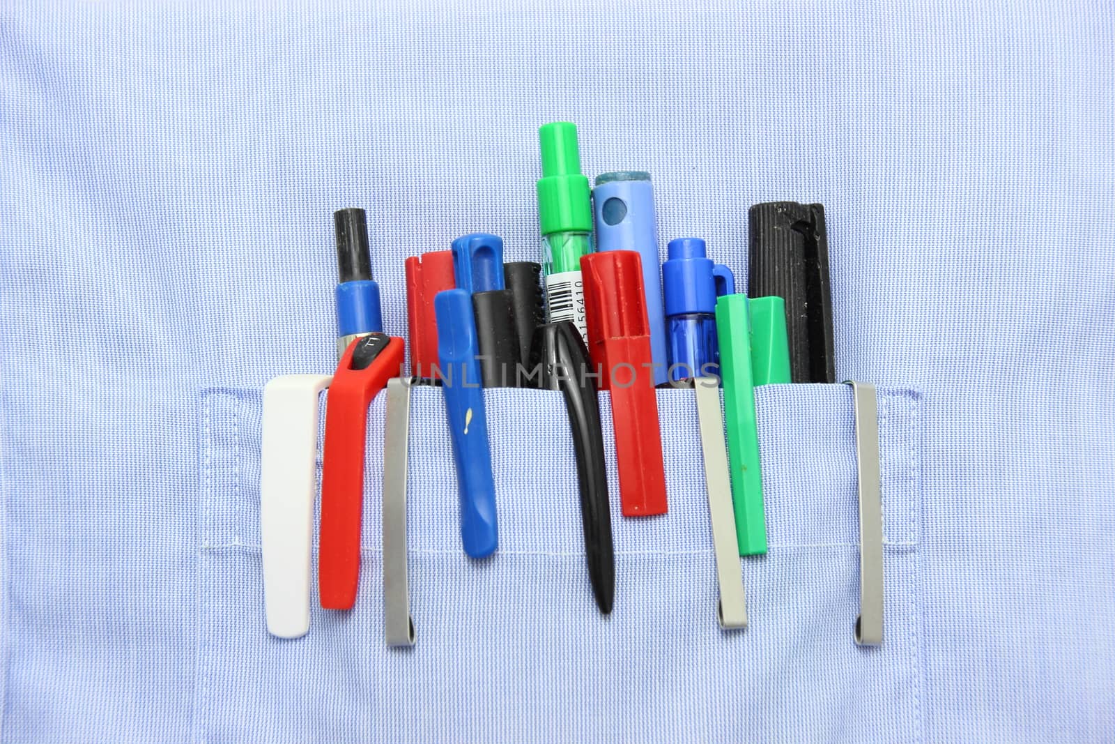 Blue shirt pocket with many different ballpoint pen