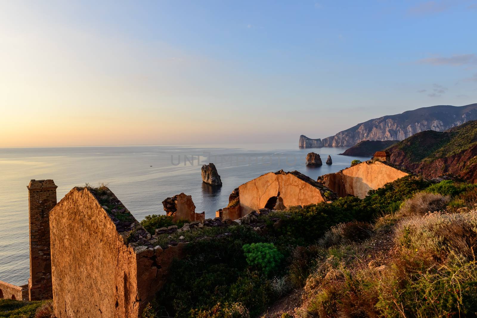 Ruins of industrial mining along the west coast of Sardinia. Panorama at sunset. The Marmora washery.