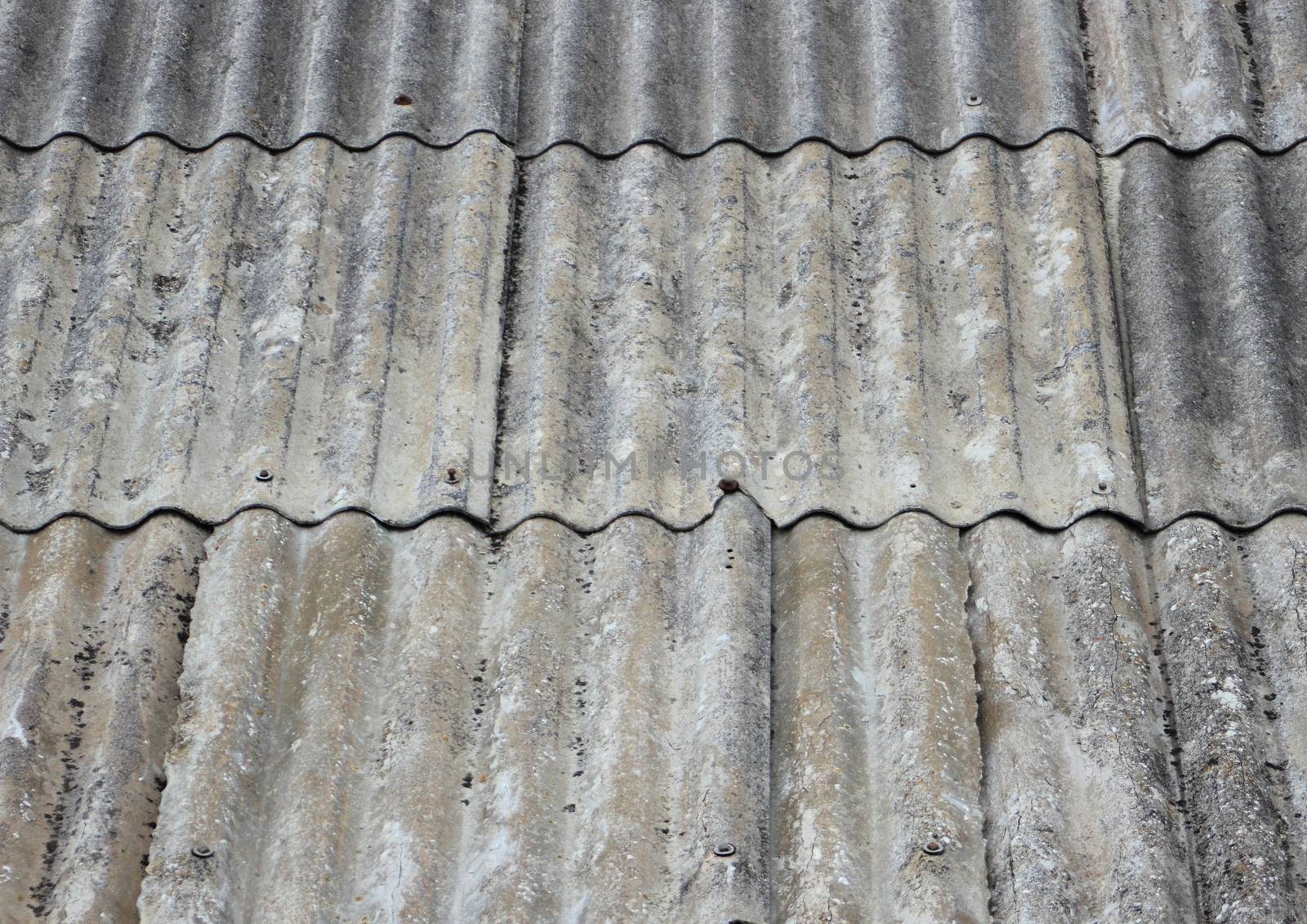 Old worn asbestos roof on small shelter