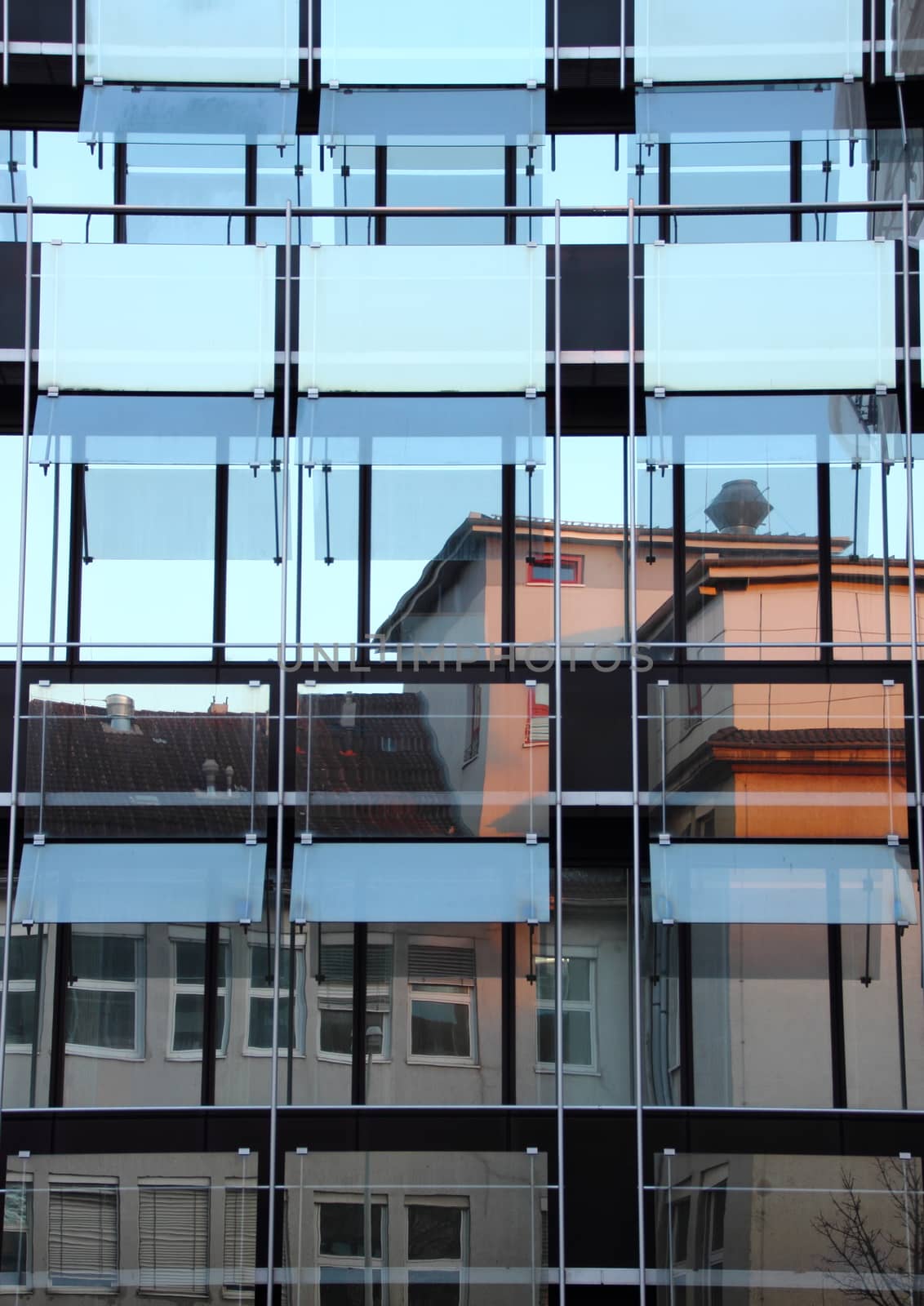 Window reflection of old building in office facade - vertical